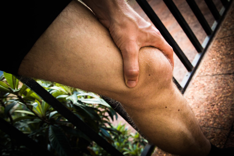 person holding a knee in pain